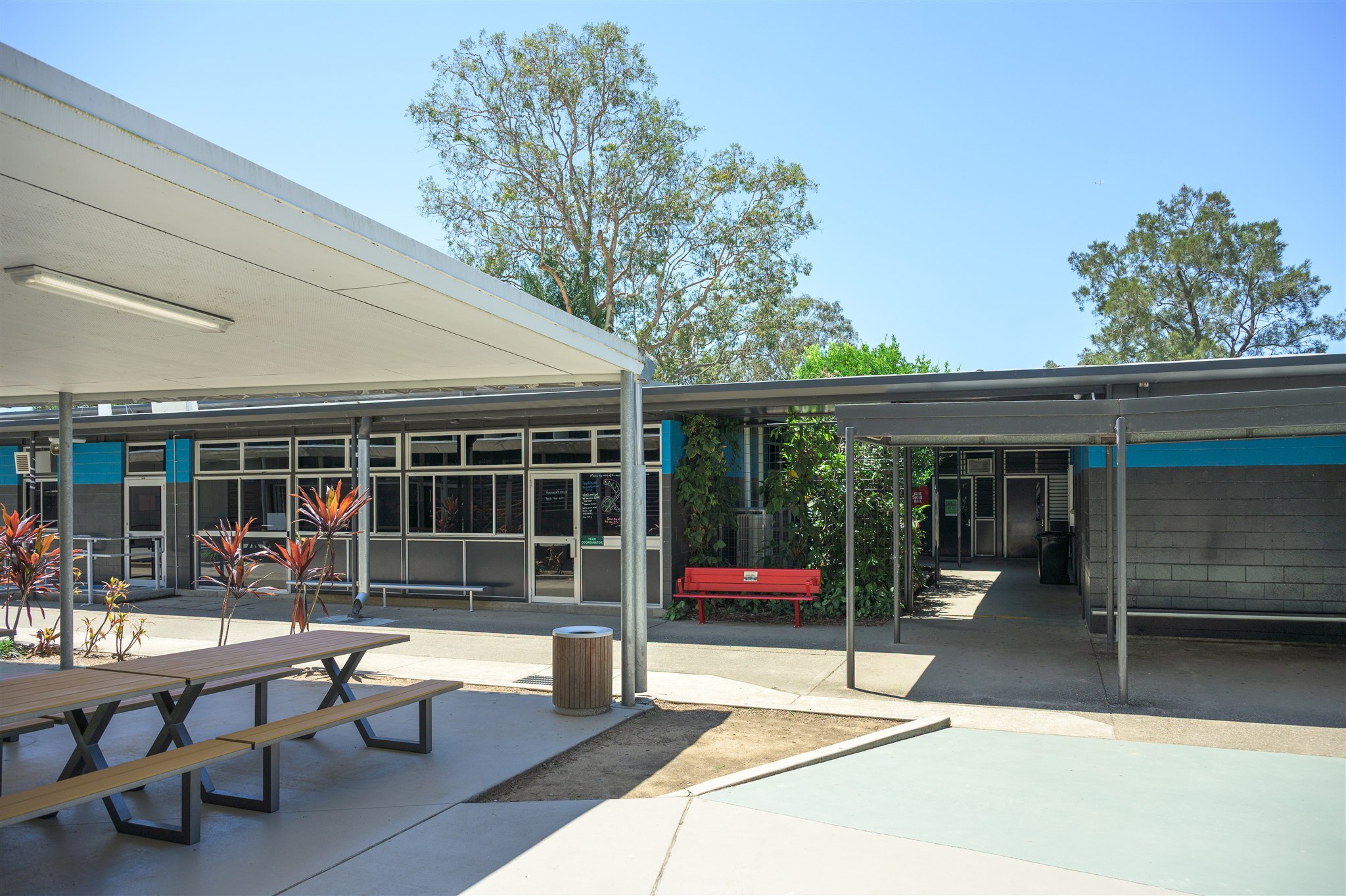 Ferny Grove State High School Red Bench Project featuring GX Outdoors Integra Ex Park Seat installed at the school campus