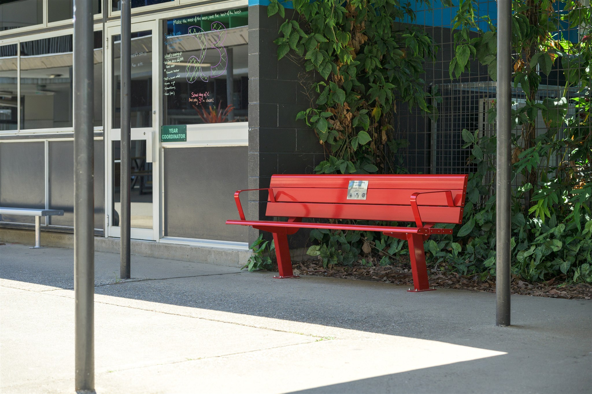 Ferny Grove State High School Red Bench Project featuring GX Outdoors Integra Ex Park Seat installed at the school campus